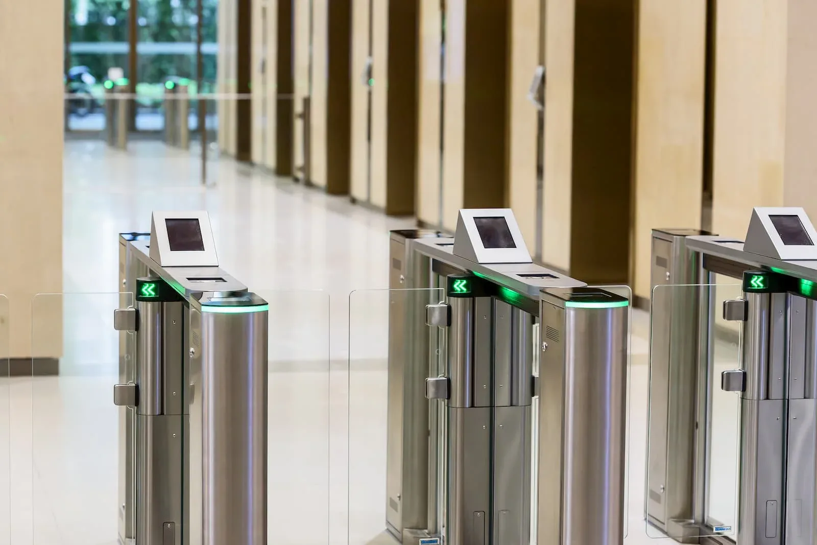 Torniquetes de control de acceso con lectores de tarjeta en el lobby de un edificio corporativo